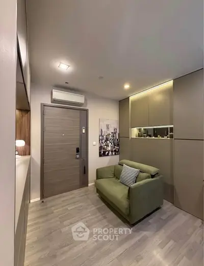 Modern living room with sleek design, featuring a cozy green sofa and stylish cabinetry, perfect for urban living.