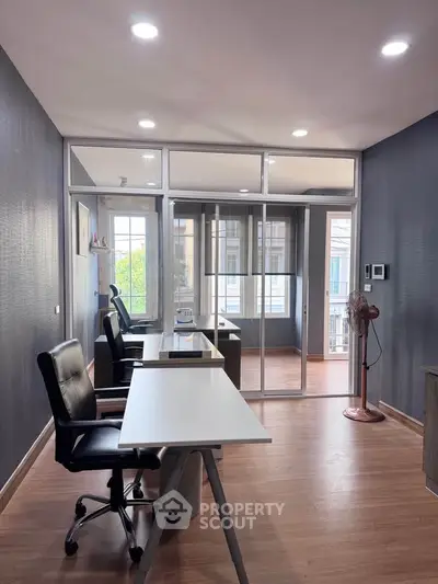 Modern office space with sleek design and natural light, featuring ergonomic chairs and spacious desks.