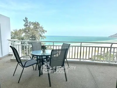 Stunning beachfront balcony with ocean view, perfect for relaxation and enjoying the sea breeze.