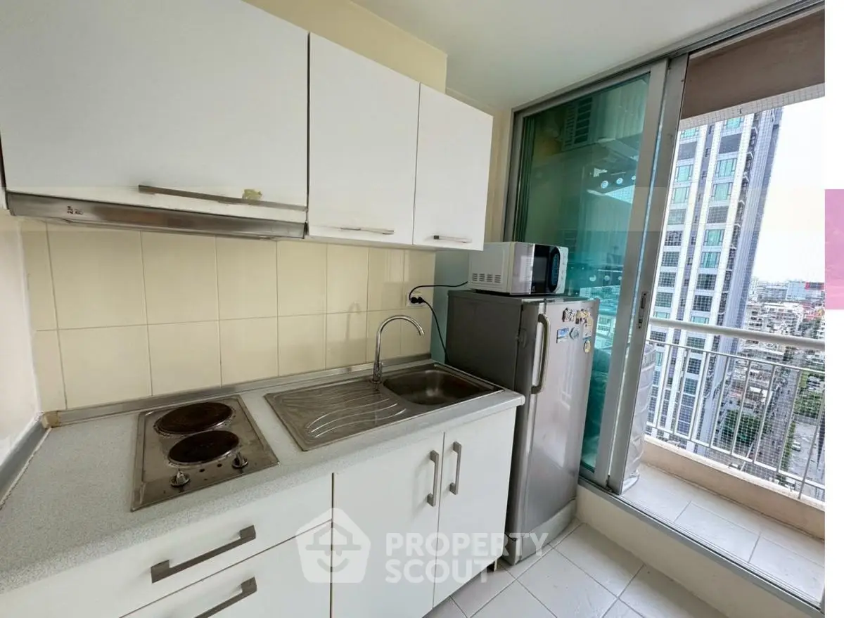 Modern kitchen with balcony view in high-rise apartment