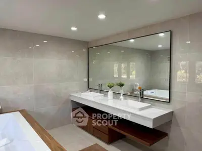 Luxurious modern bathroom with large mirror and elegant fixtures