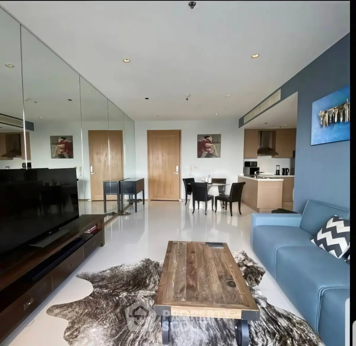 Modern living room with stylish decor, open kitchen, and cozy seating area in a contemporary apartment.