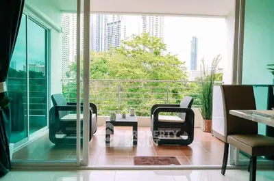 Spacious balcony with modern seating and city view, perfect for relaxation and entertaining.