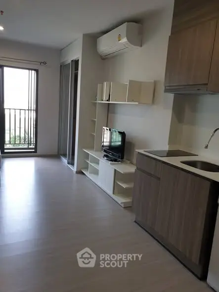 Modern apartment interior with open layout and balcony view