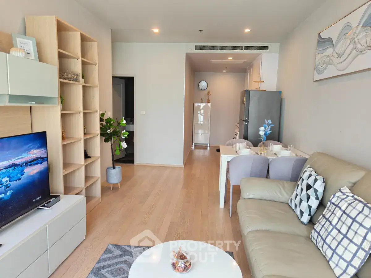 Modern living room with stylish decor and open layout, featuring a cozy seating area and dining space.