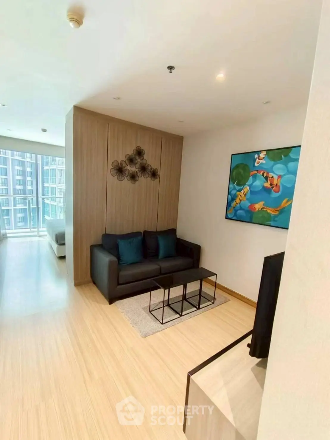 Modern living room with stylish decor and natural light in a high-rise apartment.