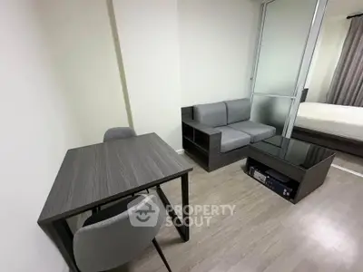 Modern studio apartment with sleek furniture and glass partition