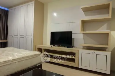 Modern bedroom with built-in wardrobe and TV unit, perfect for stylish living.