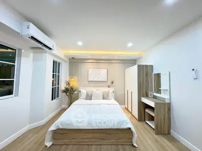 Modern bedroom with stylish decor and natural light