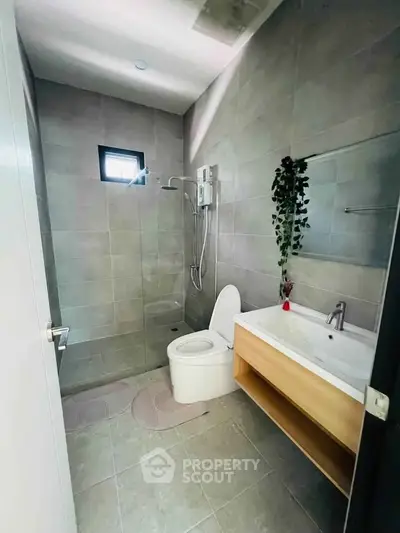 Modern bathroom with sleek design, featuring a walk-in shower and stylish vanity.