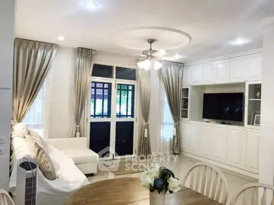 Elegant living room with white decor and built-in entertainment center