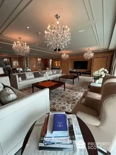 Opulent living room with elegant chandeliers, plush seating, and sophisticated decor, perfect for high-end real estate listings.