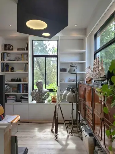 Charming study room with large window and elegant decor, perfect for inspiration and productivity.
