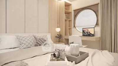 Modern bedroom with cozy decor, featuring a round window and stylish workspace.