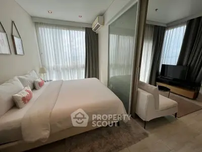 Luxurious bedroom with modern decor and large windows offering stunning views.