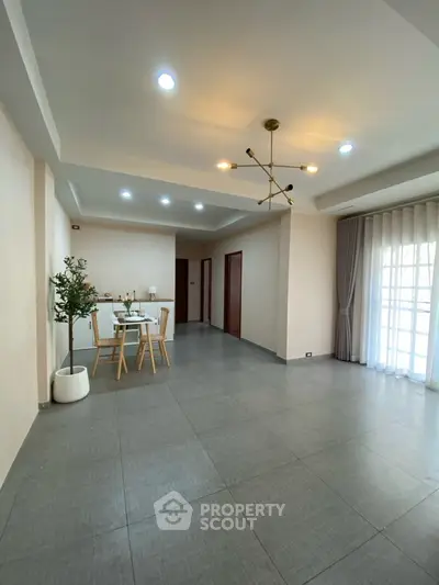 Spacious modern living room with elegant lighting and dining area