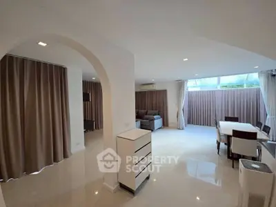 Spacious modern living room with elegant dining area and natural light