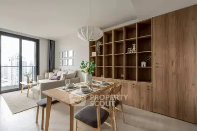 Modern living room with dining area and large windows offering city views.