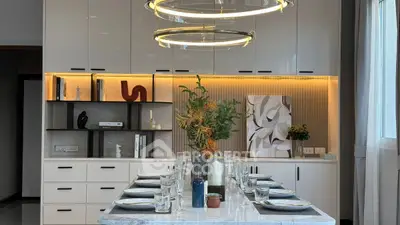 Modern dining area with elegant table setting and stylish lighting in a contemporary home.