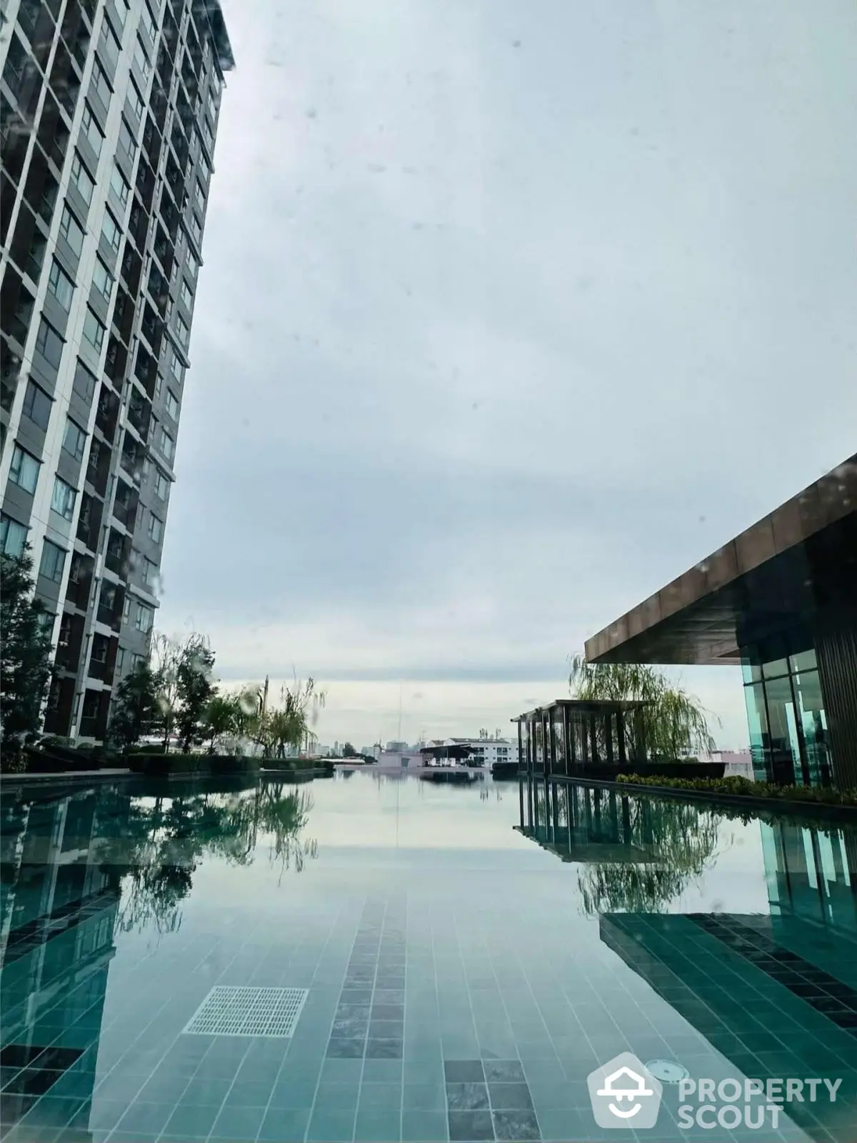 Luxurious high-rise building with serene pool and stunning sky view