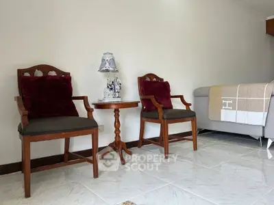 Elegant living room with classic wooden chairs and decorative lamp