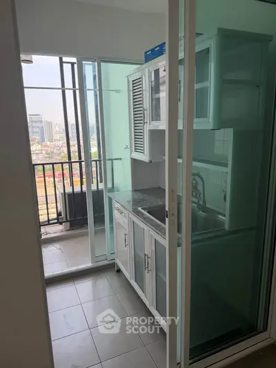 Modern kitchen with balcony view in urban apartment