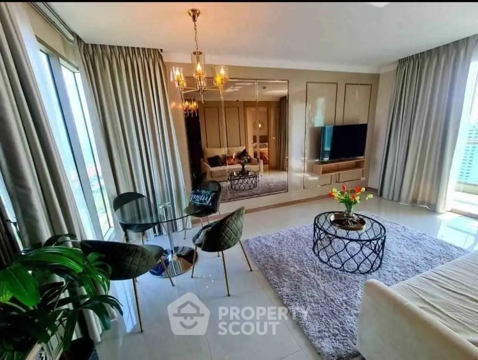 Luxurious living room with elegant decor, large windows, and modern furniture in a high-rise apartment.