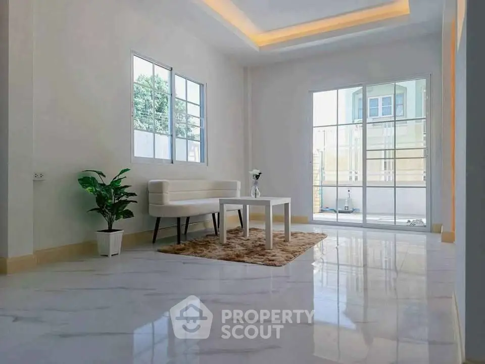 Spacious modern living room with large windows and elegant decor