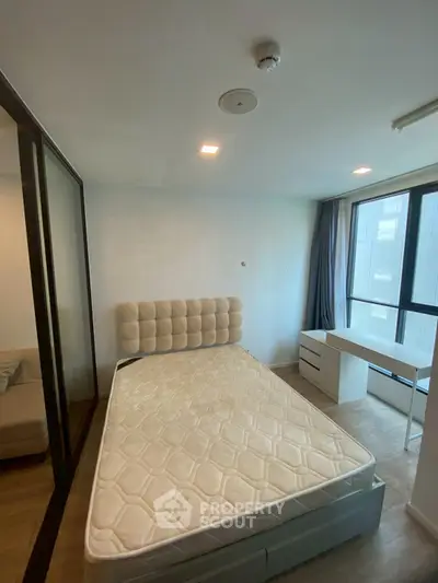 Modern bedroom with large window and minimalist furniture in urban apartment