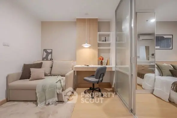 Modern studio apartment with cozy living area and stylish workspace