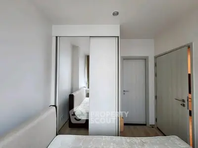 Modern bedroom with sleek design and mirrored wardrobe doors