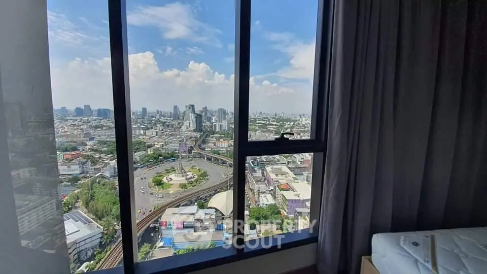 Stunning cityscape view from high-rise apartment window, showcasing urban skyline.