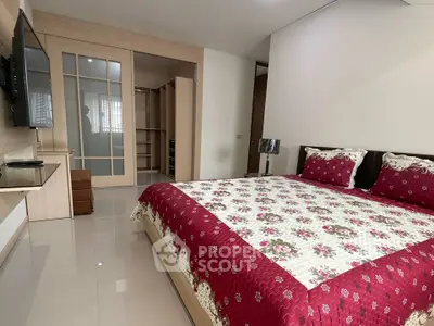 Spacious bedroom with modern decor and large bed in a stylish apartment.