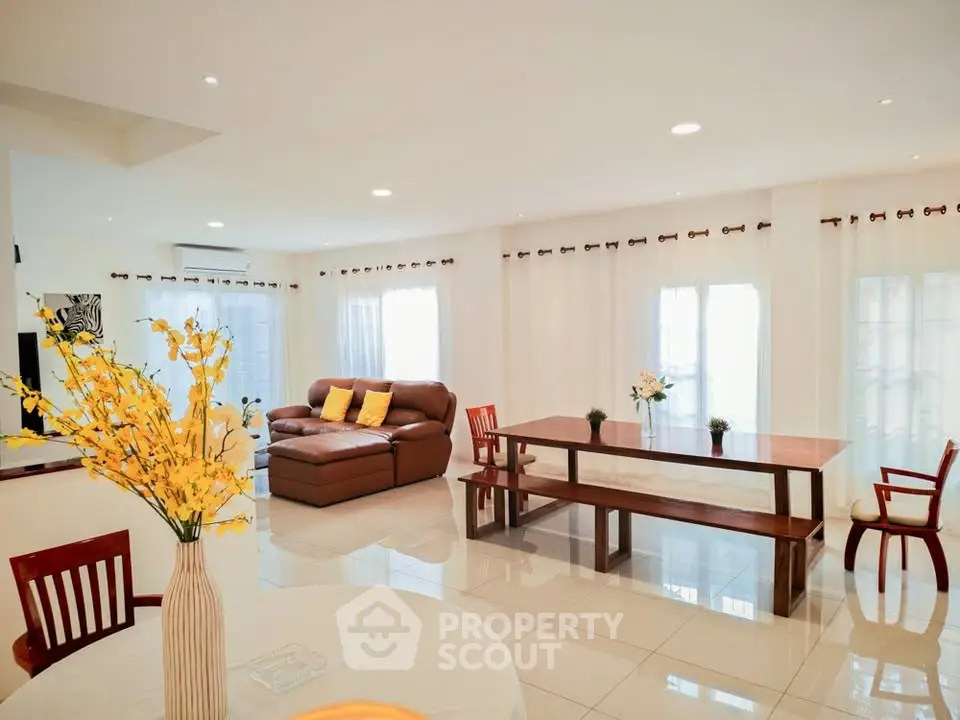 Spacious open-plan living room with elegant decor and ample natural light