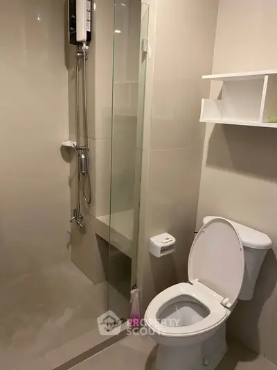 Modern bathroom with glass shower and sleek fixtures in a contemporary apartment.