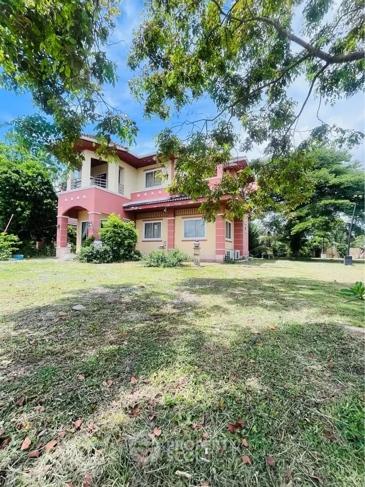 Charming two-story house with lush garden and vibrant exterior in a serene neighborhood.