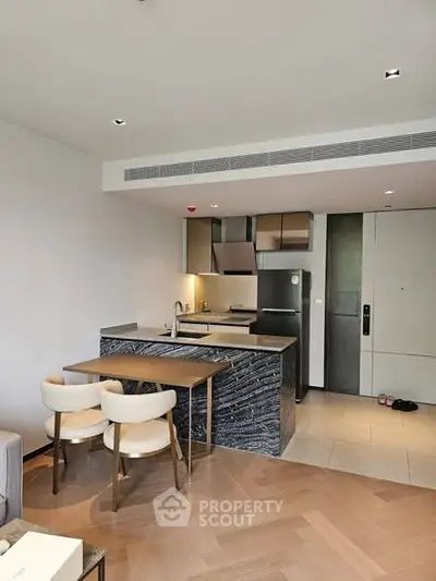 Modern open-layout kitchen with sleek design and dining area in a stylish apartment.