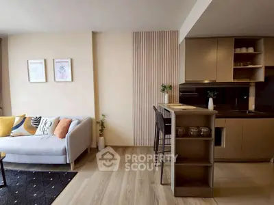 Modern open-plan living room with stylish kitchen and cozy seating area.