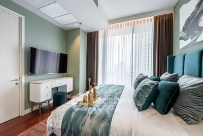 Luxurious bedroom with elegant decor and city view, featuring plush bedding and modern furnishings.