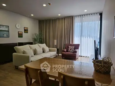 Spacious living room with modern decor and large windows for natural light.