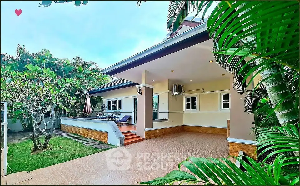 Charming tropical villa with lush garden and spacious patio, perfect for serene outdoor living.