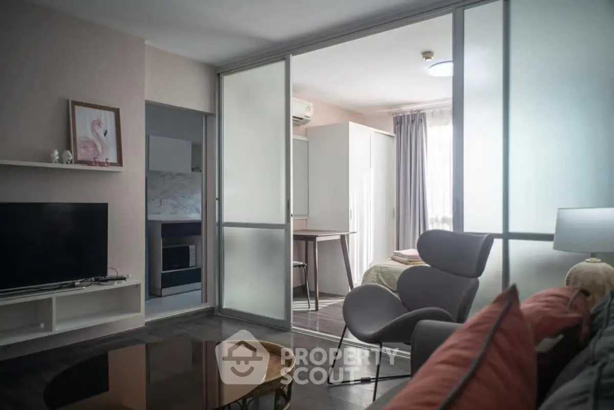 Modern studio apartment with sliding glass doors and cozy furnishings