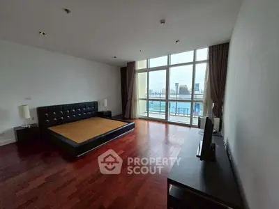Spacious bedroom with city view and modern furnishings