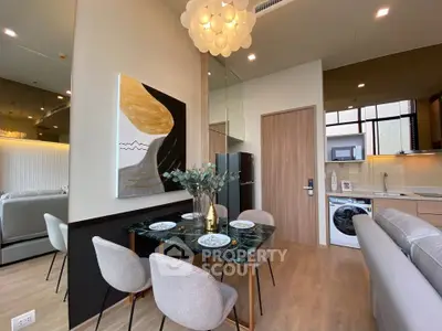 Modern open-plan living and dining area with stylish decor and integrated kitchen appliances.