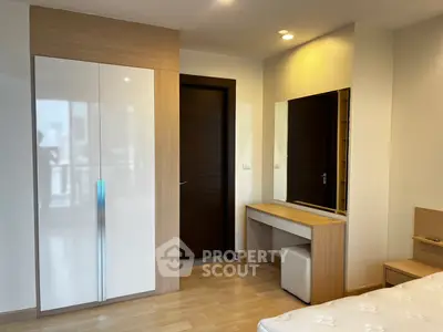 Modern bedroom with sleek wardrobe and stylish vanity in a bright, minimalist design.