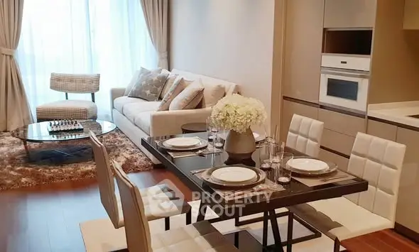 Modern living room with elegant dining area and cozy seating, featuring stylish decor and natural light.