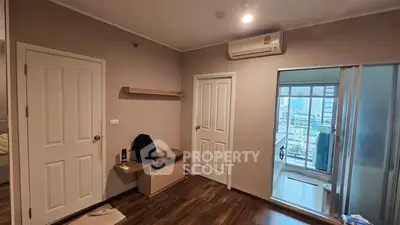 Modern bedroom with air conditioning and balcony view in urban apartment