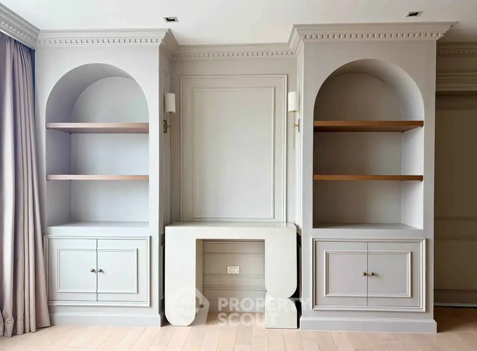 Elegant living room with built-in shelves and classic molding details