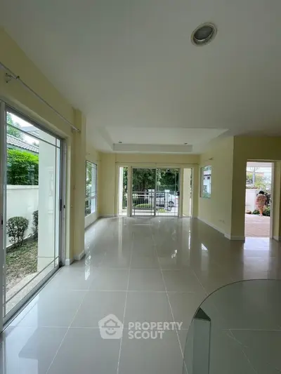 Spacious living room with large windows and garden view in modern home