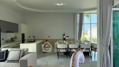 Luxurious open-plan living and dining area with modern kitchen and elegant decor.